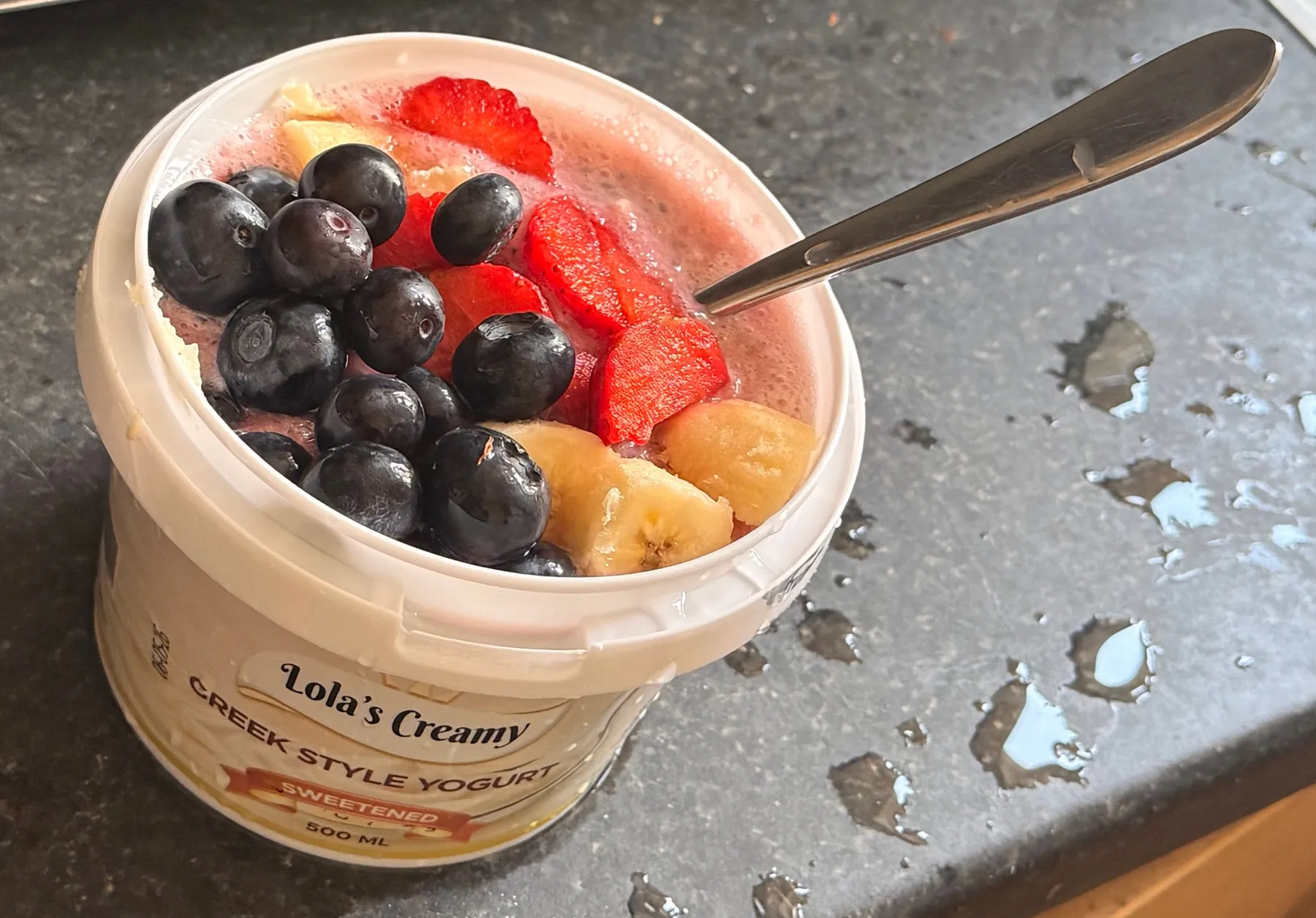 Yogurt topped with strawberries, blueberries and banana